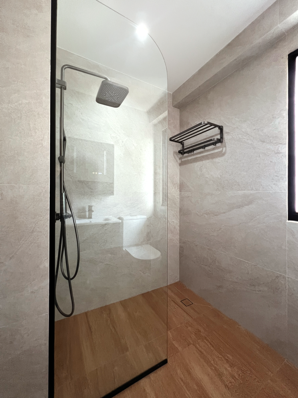 HDB bto toilet renovation with large format tiles and fixed glass panel