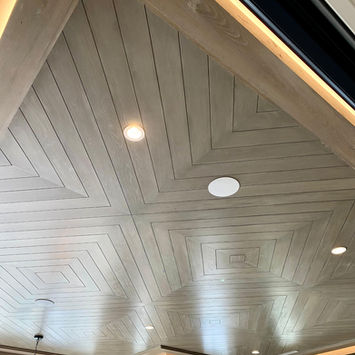 Geometric light wood vaulted ceiling with lighting