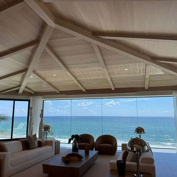 Spacious living room with vaulted ceiling and ocean view
