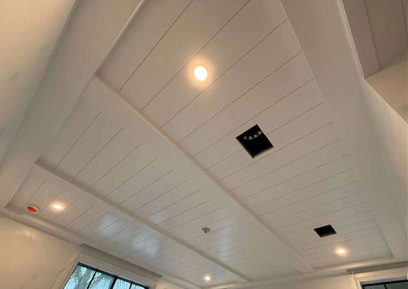 White paneled ceiling with recessed lights and vents