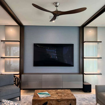 Modern living room with wall-mounted TV, built-in shelves