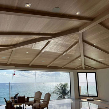 Vaulted wooden ceiling and large ocean view window