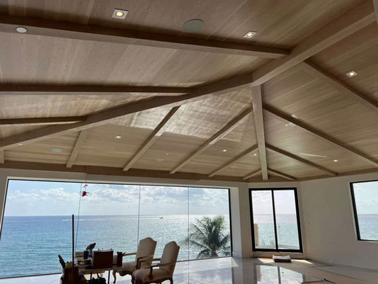 Vaulted wooden ceiling and large ocean view window
