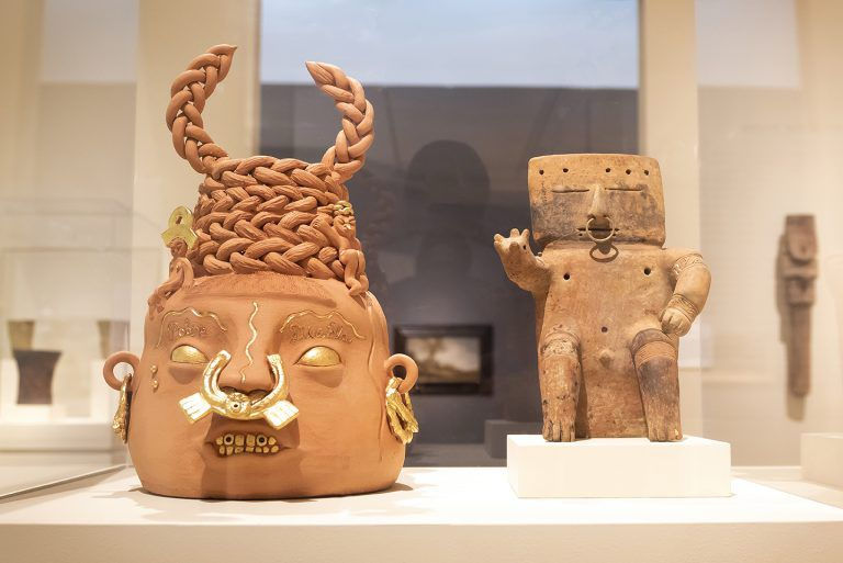 Photo: Nasher Museum, Duke University, gallery pairing of Pobre Diabla (2022) by Joel Gaitan, and Seated Male Figure made by the Quimbaya people of Colombia. Photo by J Caldwell..