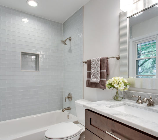 bathroom view with wood tone cabinets