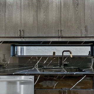 Dark brown wooden design cabinets with black handles in a kitchen designed by Bryce Cabinetry 
