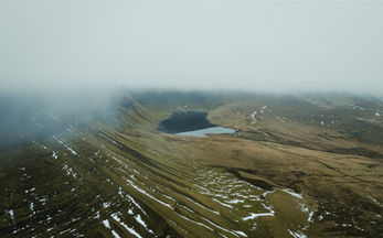 Cinematic drone landscape photography featuring aerial views of coastlines, countryside and natural scenery captured to showcase scale, perspective and atmosphere from above