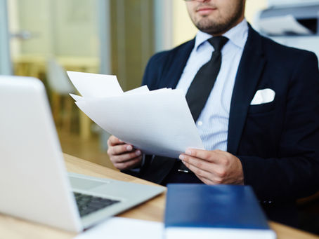 Business professional reviewing international employment documents for overseas hiring and EOR workforce solutions