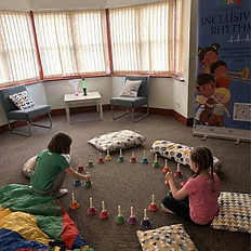 Children playing handbells in an Inclusive Rhythms program.