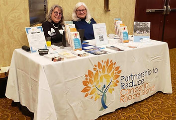 Photo of two PRCRI board members at a table with PRCRI information
