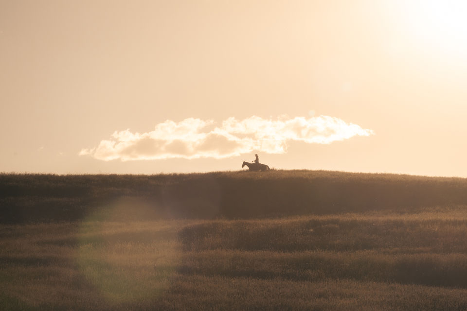 Silhouette of cowboy on horseback at sunset in western landscape by Ex Litore for Vero Smokey Bear watch campaign.