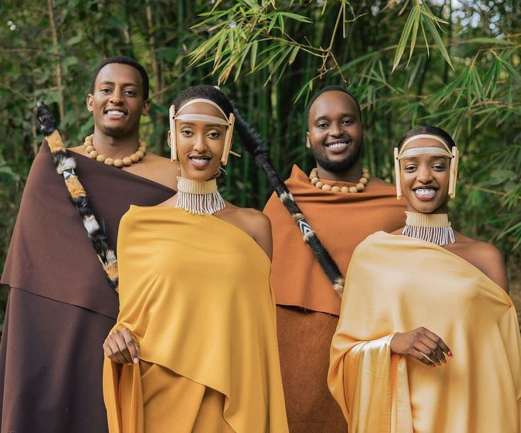 Four smiling people in traditional East African attire
