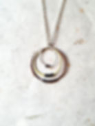 Multi hoop necklace by Copperleaf Studio shown on light background.