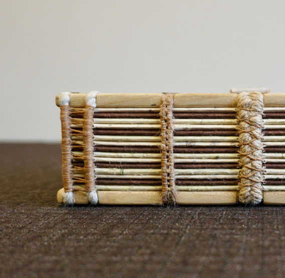 A handmade spalted sycamore notebook with beautiful exposed spine and jute supports.