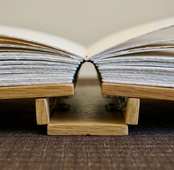 A handmade oak book and journal showing the hinging action and flexibility of the wooden Dos Rapporté binding.