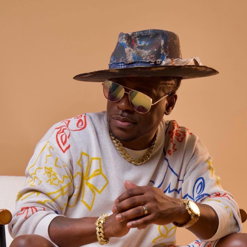 Roi Chip Anthony in a hat and sunglasses, promotional portrait