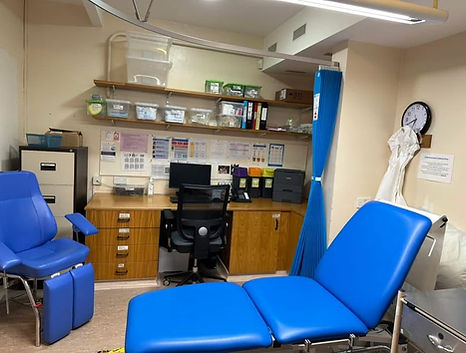 Clinical treatment room inside a GP surgery cleaned daily by Prism Commercial Cleaning, including clinical surfaces, sinks and eximination areas.