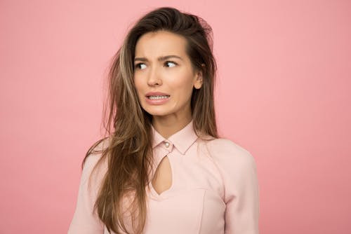 woman bitting lip