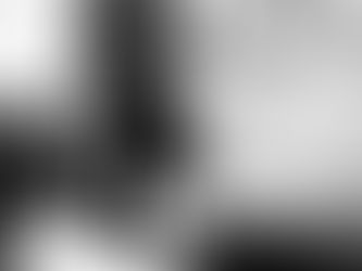 Overwhelmed man sitting in a chair with head in hands — struggling with emotional regulation