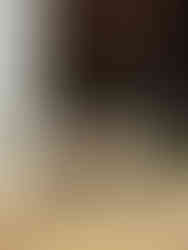 Three baby goats peek out from their barn at The Montbello Barn petting zoo