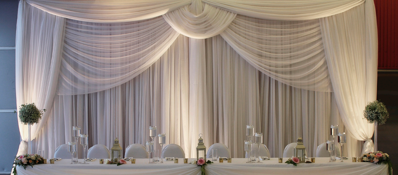 Luxury ceiling fabric draping transforming an elegant wedding venue