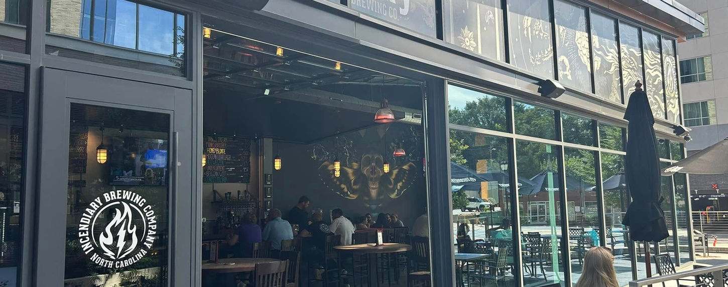 Incendiary Brewing Co. storefront with people enjoying the bar