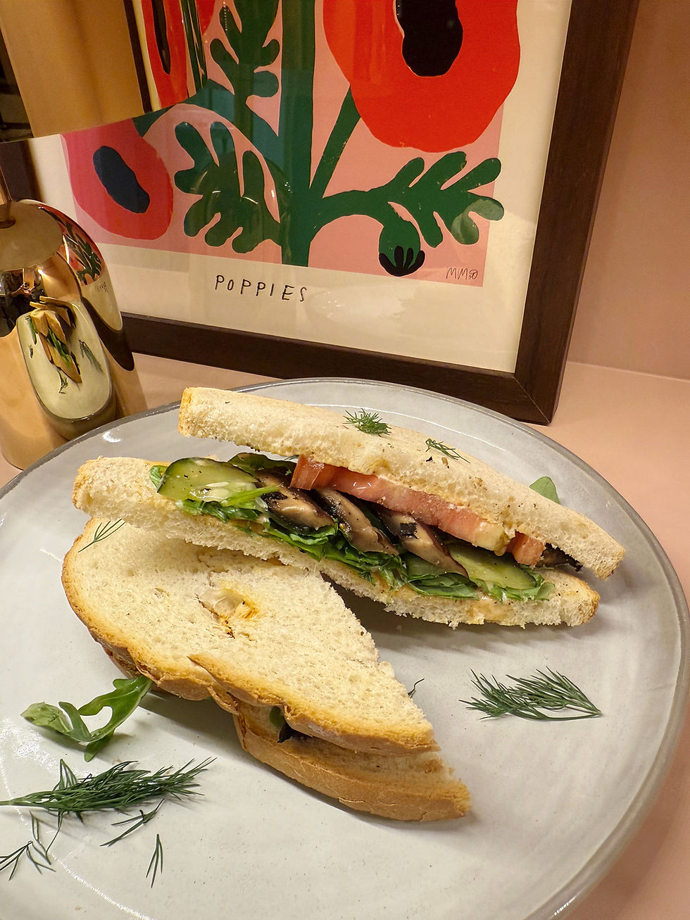 A delicious veggie sandwich with roasted eggplant, mushrooms, and mozzarella on a plate