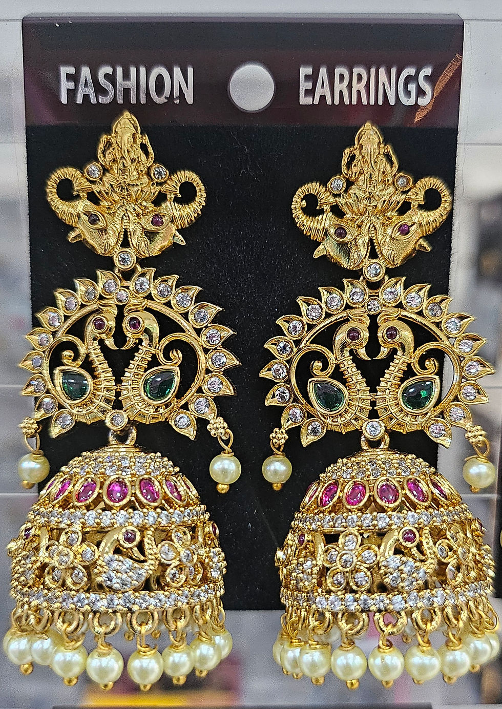 Golden peacock earrings, studded with gems, displaying intricate design and detailing for sale JeJo Stores
