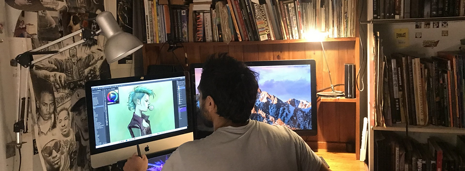 A picture of Max in his studio drawing for a client.