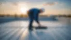 Eye-level view of a technician inspecting a GRP roof for maintenance