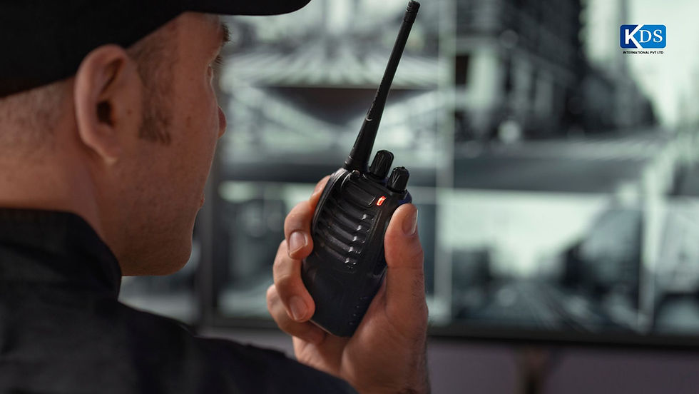 Security guard communicating via walkie-talkie while monitoring CCTV surveillance screens.