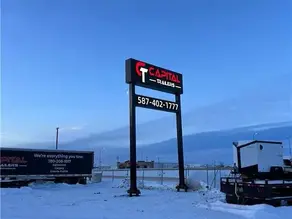 Custom double-sided illuminated light box sign installed on existing steel poles in Canada