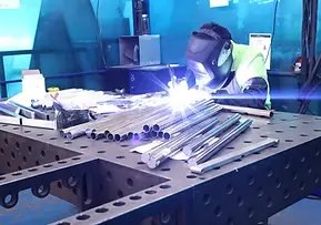 Welding metal frame for led sign letters in workshop