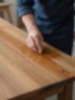 Hand oiling a wooden table