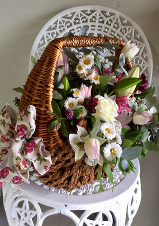 Wicker basket with white and pink container flowers gallery