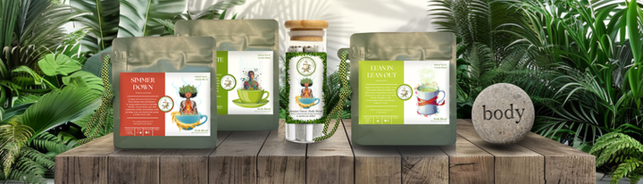 “Body Collection herbal tea and smoke blends by Double Entendre Tea Company, featuring Simmer Down, Clean Slate Club, and Lean In–Lean Out pouches with a matching pre-roll jar displayed on a wooden surface surrounded by lush green foliage.”