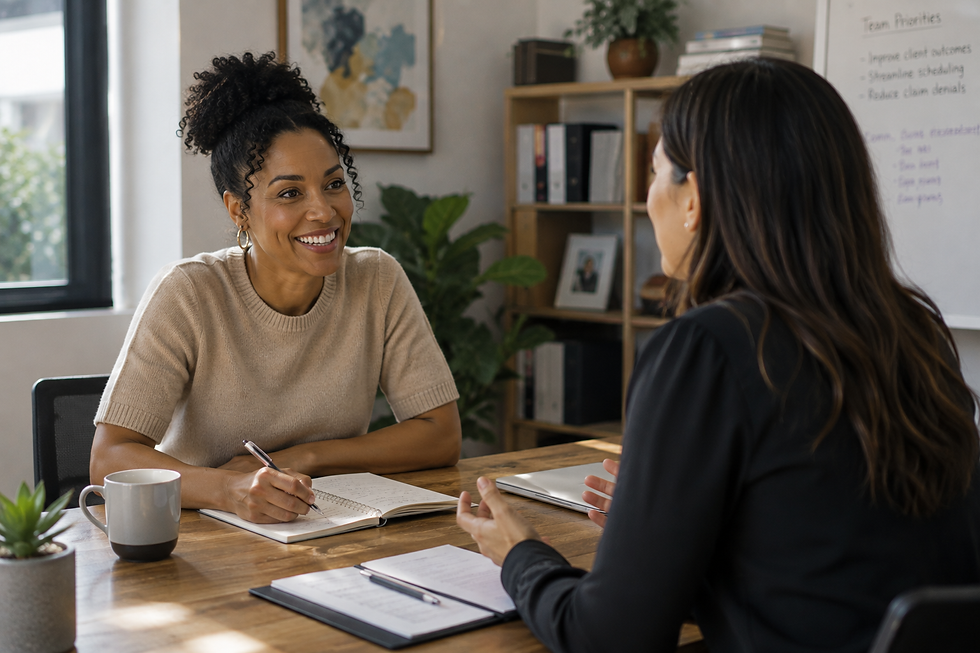 Two ABA practice leaders meet across a table to discuss operations, one taking notes while reviewing priorities like improving client outcomes, streamlining scheduling, and reducing claim denials on the whiteboard behind them.