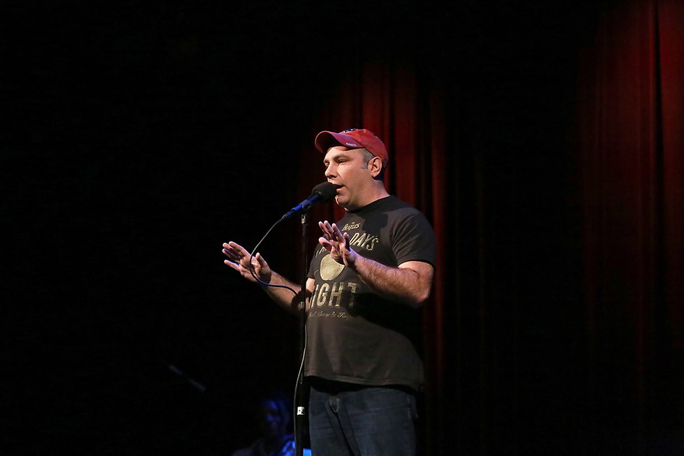 Matthew Dicks on stage at a Moth Storyslam.
