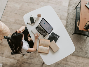 Girl on computer at desk.