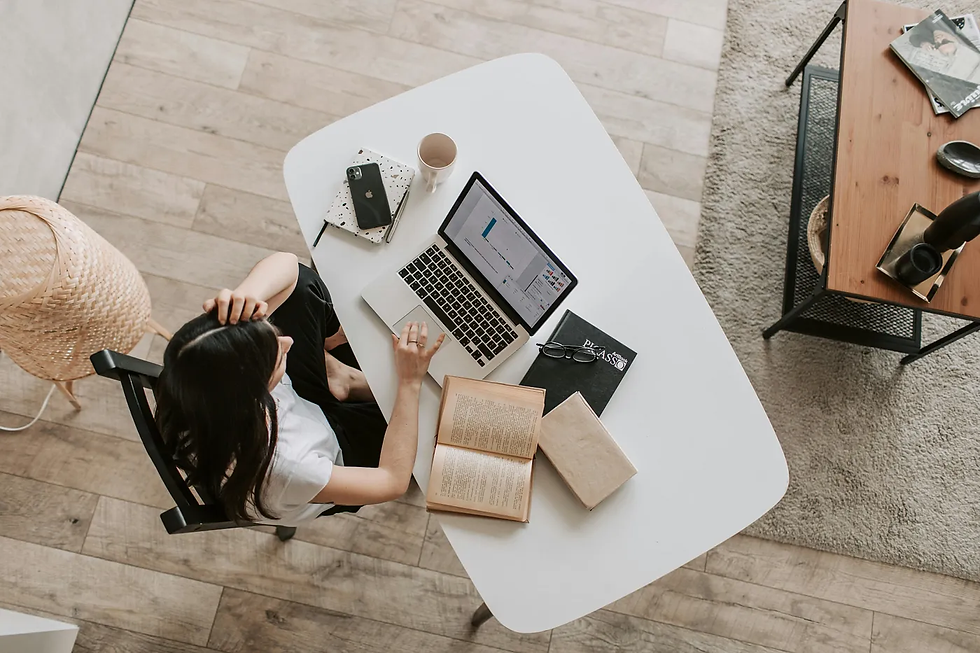 Girl on computer at desk.