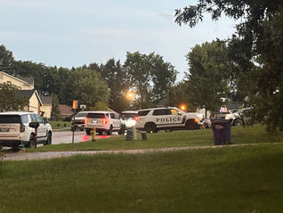 Multiple Troy Police Department vehicles are parked along Shingle Oak Court during a large law enforcement response in Troy, Missouri.