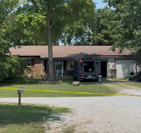 Law enforcement crime scene tape blocks access to a residence on Pinewood Drive in Winfield, Missouri, following the conclusion of an hours-long barricaded subject incident and officer-involved shooting.