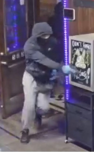 Surveillance images released by the Lincoln County Sheriff's Office showing three suspects entering The SPOT Smoke and Play during the Dec. 26, 2025 robbery and shooting in Elsberry, Missouri.