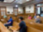 Crowd gathered inside the Lincoln County Commission meeting room in Troy, Missouri, including elected officials, department heads and members of the public attending a commission meeting.