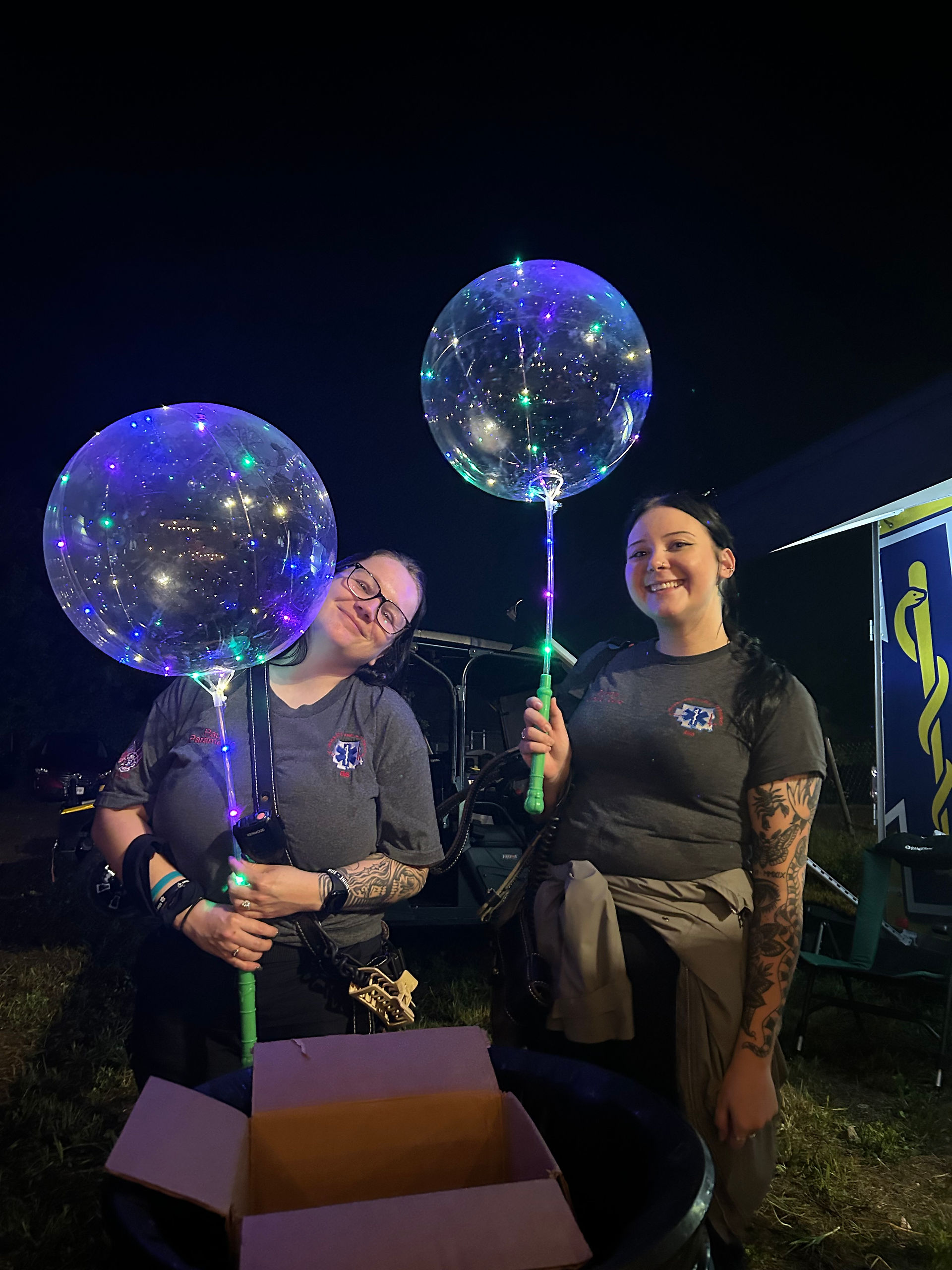 Lincoln County Ambulance District personnel pose with illuminated balloon toys during the Lincoln County Fair.