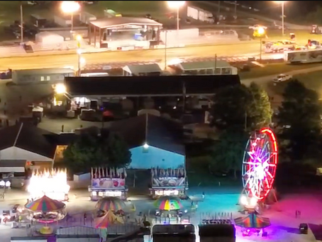 Aerial view of the Lincoln County Fairgrounds during the 2026 Lincoln County Fair in Troy, Missouri, showing the midway, livestock barns, vendors and crowds gathered for Fair Week.