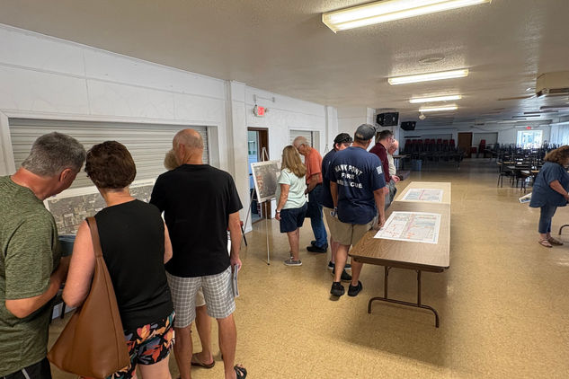 Residents review Route 47 construction maps and speak with project representatives during a MoDOT public informational meeting at the Hawk Point Lions Club in Hawk Point, Missouri.
