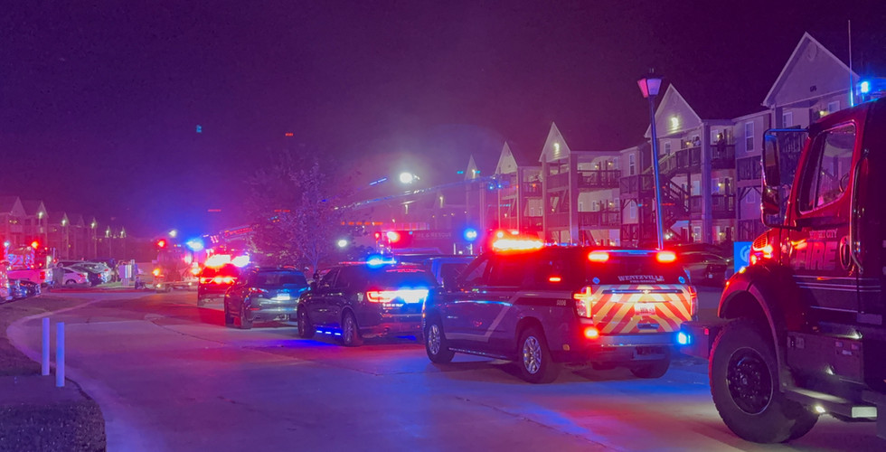Emergency vehicles from multiple departments line the roadway during a second-alarm apartment fire near Killdeer Circle and Mette Road in Moscow Mills.