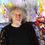 Thumbnail: the artist Peter Nottrott with his vibrant semi abstract seascape painting