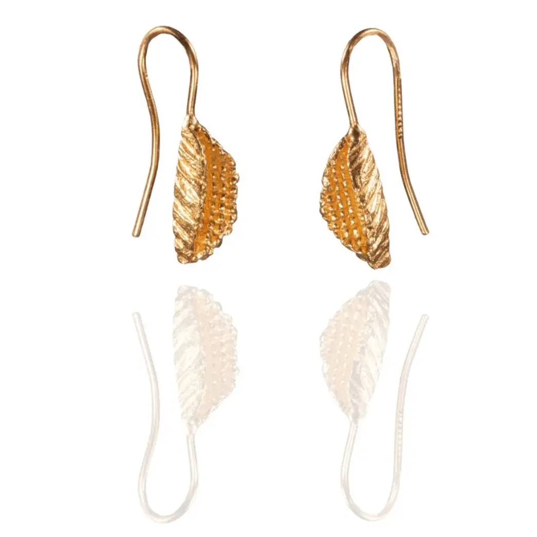 Close-up of handmade gold leaf earrings showing sculpted pod-like form and granulated texture, crafted in gold-plated brass